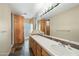 Double vanity bathroom with slate floors and wood cabinets at 12129 N 114Th Way, Scottsdale, AZ 85259