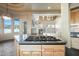 Kitchen island with cooktop and views into the adjacent living area at 12129 N 114Th Way, Scottsdale, AZ 85259