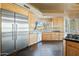 Stainless steel refrigerator and ample wood cabinetry in kitchen at 12129 N 114Th Way, Scottsdale, AZ 85259
