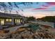 Stunning pool and waterfall feature at dusk at 12129 N 114Th Way, Scottsdale, AZ 85259