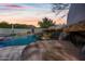 Close-up of a natural rock waterfall feature next to a pool at 12129 N 114Th Way, Scottsdale, AZ 85259