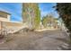 Large backyard with dirt and some small trees at 12858 W Wilshire Dr, Avondale, AZ 85392