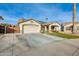 Single-story home with a two-car garage and a neatly kept lawn at 12858 W Wilshire Dr, Avondale, AZ 85392
