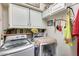 Laundry room with washer, dryer, and cabinets at 12858 W Wilshire Dr, Avondale, AZ 85392