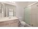 Bright bathroom featuring a glass enclosed walk-in shower, single sink vanity, and a large mirror at 1351 N Pleasant Dr # 1102, Chandler, AZ 85225
