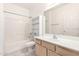 Well-lit bathroom featuring a shower-tub combo, built-in shelving, and a single sink vanity at 1351 N Pleasant Dr # 1102, Chandler, AZ 85225