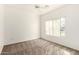 Bright bedroom with a ceiling fan, neutral carpeting, and a window with vertical blinds at 1351 N Pleasant Dr # 1102, Chandler, AZ 85225