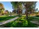 A grassy common area provides residents with walking trails and a fenced tennis court at 1351 N Pleasant Dr # 1102, Chandler, AZ 85225