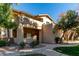 Exterior view of the condo featuring a well-maintained stucco facade, manicured landscaping and a walkway leading to the entrance at 1351 N Pleasant Dr # 1102, Chandler, AZ 85225
