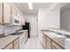 Galley kitchen has black appliances, neutral cabinets, and tile floors at 1351 N Pleasant Dr # 1102, Chandler, AZ 85225