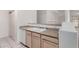 Kitchen sink and countertop area featuring neutral cabinets and tile floors at 1351 N Pleasant Dr # 1102, Chandler, AZ 85225