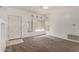 Open concept living room with neutral carpet, white walls, and a view to the entryway at 1351 N Pleasant Dr # 1102, Chandler, AZ 85225