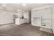 Open concept living room with neutral carpet, white walls, breakfast bar and a view to the kitchen at 1351 N Pleasant Dr # 1102, Chandler, AZ 85225