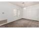 Open living room with new carpet, chandelier, and large window at 1351 N Pleasant Dr # 1102, Chandler, AZ 85225