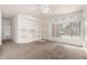 Open concept living room with neutral carpet, white walls, and a view to the entryway at 1351 N Pleasant Dr # 1102, Chandler, AZ 85225