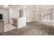 Open concept living room with neutral carpet, white walls, breakfast bar and a view to the kitchen at 1351 N Pleasant Dr # 1102, Chandler, AZ 85225