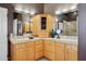 Double vanity bathroom with light wood cabinets and a corner cabinet at 15529 E Sycamore Dr, Fountain Hills, AZ 85268