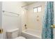 Cozy bathroom featuring a bathtub with a shower, a standard toilet, and blue patterned shower curtain at 19520 N 65Th Ave, Glendale, AZ 85308