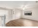 Open bonus room with neutral walls, wood-look floors, bright window, and a ceiling fan at 19520 N 65Th Ave, Glendale, AZ 85308