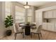 Cozy dining area featuring a modern light fixture, built-in cabinets, and bright windows at 19520 N 65Th Ave, Glendale, AZ 85308
