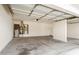 Three-car garage featuring concrete floors, two garage doors, water heater, and access to storage area at 19520 N 65Th Ave, Glendale, AZ 85308