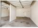 A clean three-car garage with an attached storage room, featuring concrete floors and two garage doors at 19520 N 65Th Ave, Glendale, AZ 85308