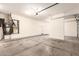 Clean three car garage with bright lighting and a water heater on the left side at 19520 N 65Th Ave, Glendale, AZ 85308