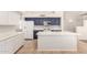 Well-equipped kitchen with navy and white cabinets, an island, and modern appliances for a chef-inspired cooking experience at 19520 N 65Th Ave, Glendale, AZ 85308