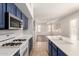 Stylish kitchen with stainless steel appliances, a large island and a seamless transition into the adjacent living area at 19520 N 65Th Ave, Glendale, AZ 85308