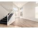 Bright living room featuring high ceilings, modern floors, large windows, and a staircase at 19520 N 65Th Ave, Glendale, AZ 85308