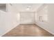 A view of a spacious living room with light-colored walls, wood floors, and natural light from the windows at 19520 N 65Th Ave, Glendale, AZ 85308