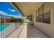 A covered patio alongside a pool offers a shaded outdoor space with iron fencing for safety and enjoyment at 19520 N 65Th Ave, Glendale, AZ 85308