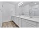 Double vanity bathroom with modern white cabinets and a large mirror at 1959 E Hampton Ln # 102, Gilbert, AZ 85295