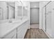 Bright bathroom with double sinks, shower, and wood-look tile floor at 1959 E Hampton Ln # 102, Gilbert, AZ 85295