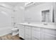 Bathroom with double sinks, bathtub, and wood-look tile floor at 1959 E Hampton Ln # 102, Gilbert, AZ 85295