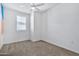 Well-lit bedroom with a window, ceiling fan and carpet flooring at 1959 E Hampton Ln # 102, Gilbert, AZ 85295