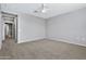 Spacious bedroom with ceiling fan and plush carpeting at 1959 E Hampton Ln # 102, Gilbert, AZ 85295