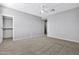 Well-lit bedroom with ceiling fan, carpet, and walk-in closet at 1959 E Hampton Ln # 102, Gilbert, AZ 85295