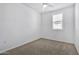 Bright bedroom with carpeted floor, window with shutters, and ceiling fan at 1959 E Hampton Ln # 102, Gilbert, AZ 85295