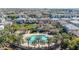 Community pool, surrounded by palm trees and homes at 1959 E Hampton Ln # 102, Gilbert, AZ 85295