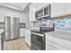 Modern kitchen featuring stainless steel appliances and a gray quartz island at 1959 E Hampton Ln # 102, Gilbert, AZ 85295