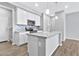 Modern kitchen with white cabinets, stainless steel appliances, and a gray quartz island at 1959 E Hampton Ln # 102, Gilbert, AZ 85295
