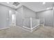 Upstairs hallway with carpet and white railing leading to bedrooms at 1959 E Hampton Ln # 102, Gilbert, AZ 85295