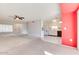 Open kitchen with white cabinets and a view of the living room at 19811 N 130Th Ave, Sun City West, AZ 85375