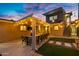 A backyard with a covered patio, complete with outdoor lighting, seating, and desert landscape features at 2306 N 55Th St, Phoenix, AZ 85008