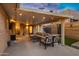 Inviting covered patio with comfortable seating, string lights, and outdoor entertainment area at 2306 N 55Th St, Phoenix, AZ 85008