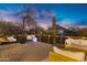 Stunning deck featuring a desert landscape with mountain views, highlighted by stylish outdoor seating and ambient lighting at 2306 N 55Th St, Phoenix, AZ 85008