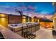 Luxurious hot tub area with built-in seating, lush greenery, and ambient lighting for relaxation at 2306 N 55Th St, Phoenix, AZ 85008