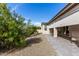Manicured backyard showcasing mature trees, gravel landscaping, and a covered patio at 2306 N Floyd Dr, Mesa, AZ 85215