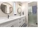 Bright bathroom featuring double sinks, modern fixtures, and glass shower at 2306 N Floyd Dr, Mesa, AZ 85215